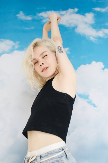 Smiling person in a dynamic yoga pose against a bright background, looking energized.